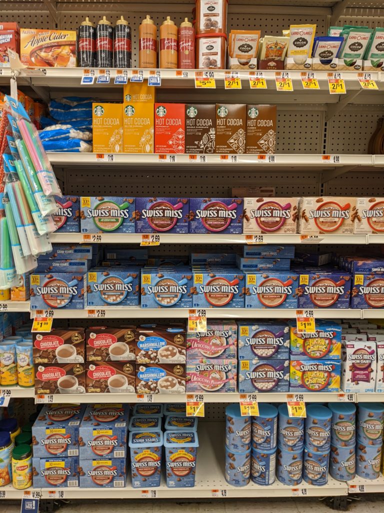 Grocery store shelves showing boxes of hot chocolate.